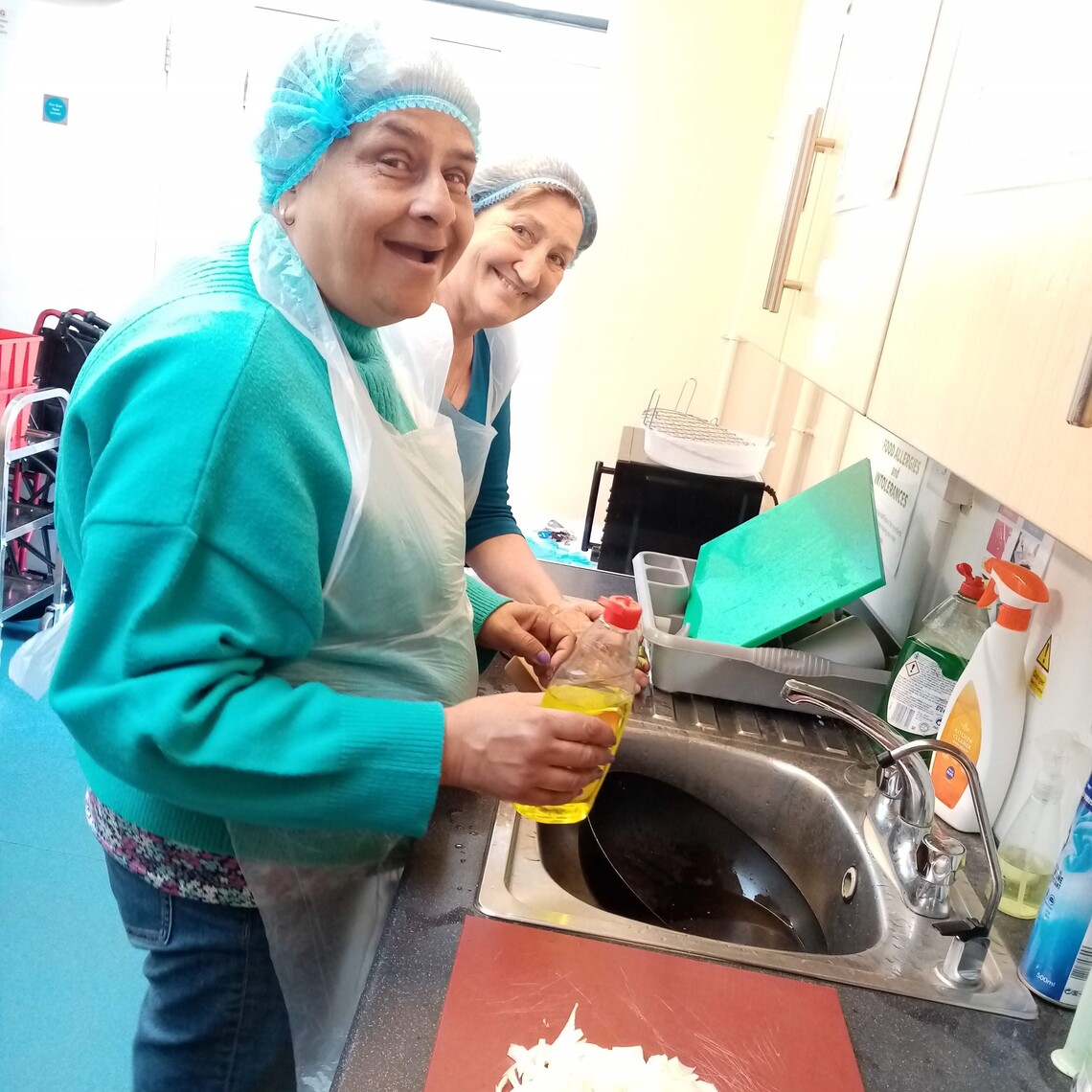Photo of two people in the kitchen washing up